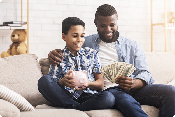 Father and teen son discussing saving money